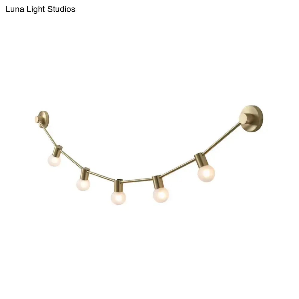Brass-finished wall light with five exposed bulb base sockets in a gentle curve for 110v 220v-240v use