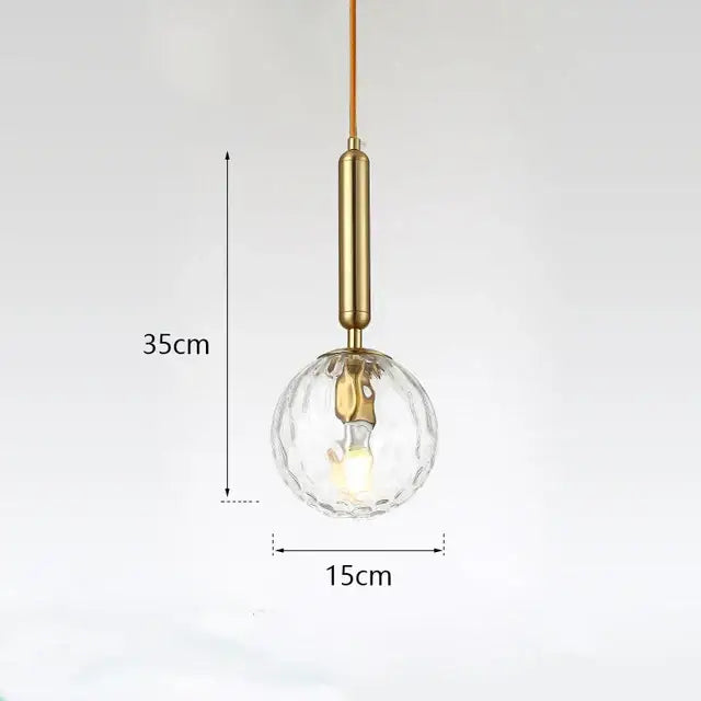 Modern gold glass ball led pendant light with brass cylindrical stem and clear faceted decorbites glass ball globe