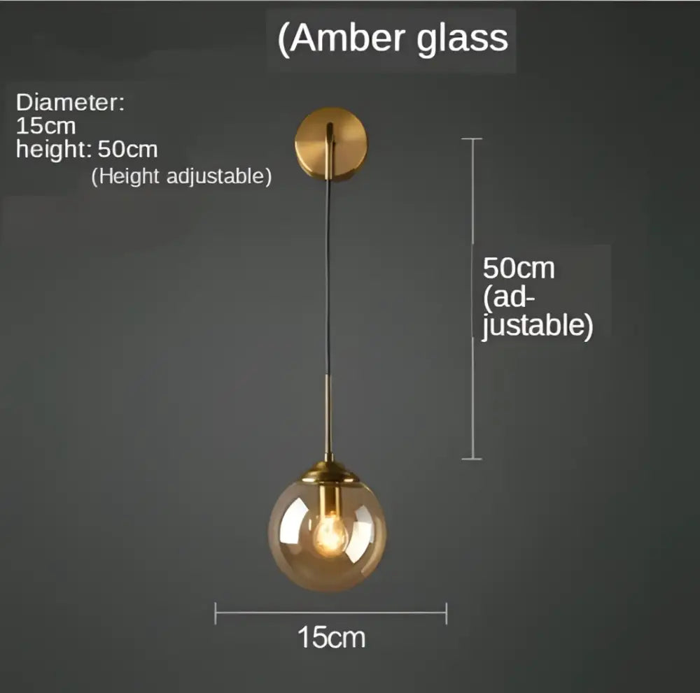 Modern gold glass ball wall sconce light fixture with amber glass pendant and brass-finished mounting plate by decorbites