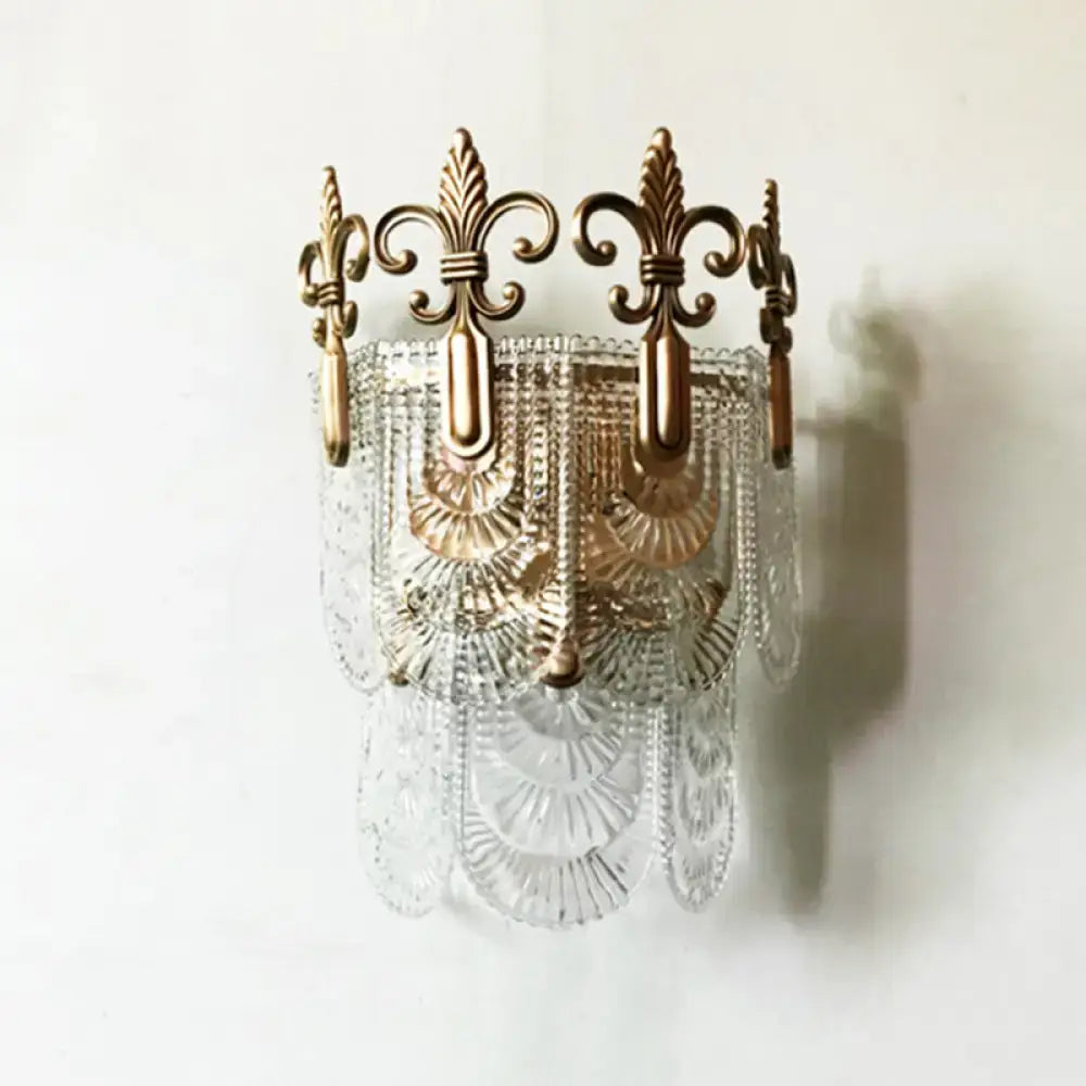 Antique brass and clear cut glass wall light with ornate fleur-de-lis detailing for 110v-120v or 220v-240v use