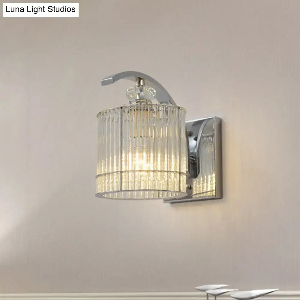Modern gold wall mounted lamp with clear crystal shade featuring a chrome finished wall sconce and cylindrical glass design