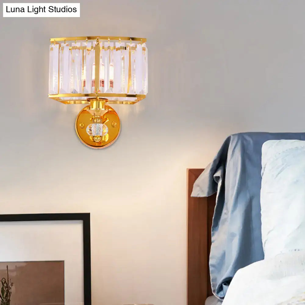 Modern gold wall sconce featuring vertical clear crystal rods and a central clear crystal block for bedroom lighting