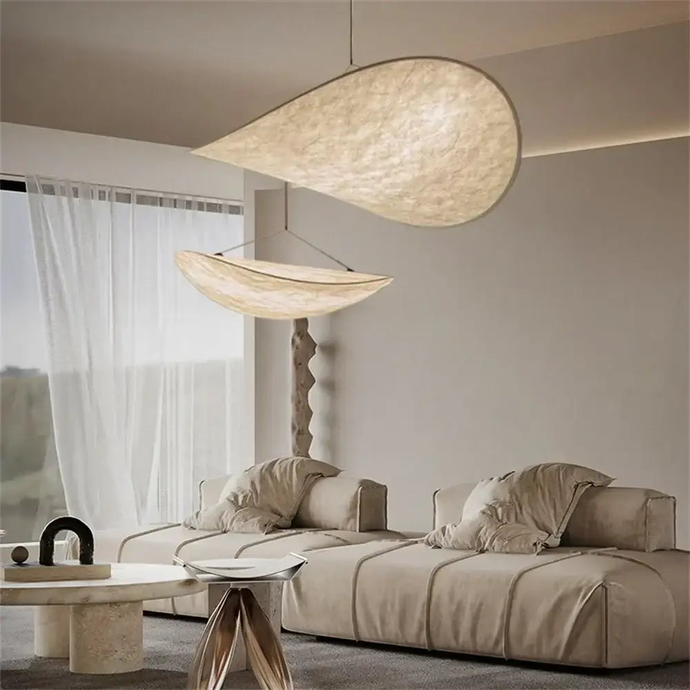 Cream-colored organic-shaped pendant light with textured woven fabric finish for bedroom decorbites japanese style