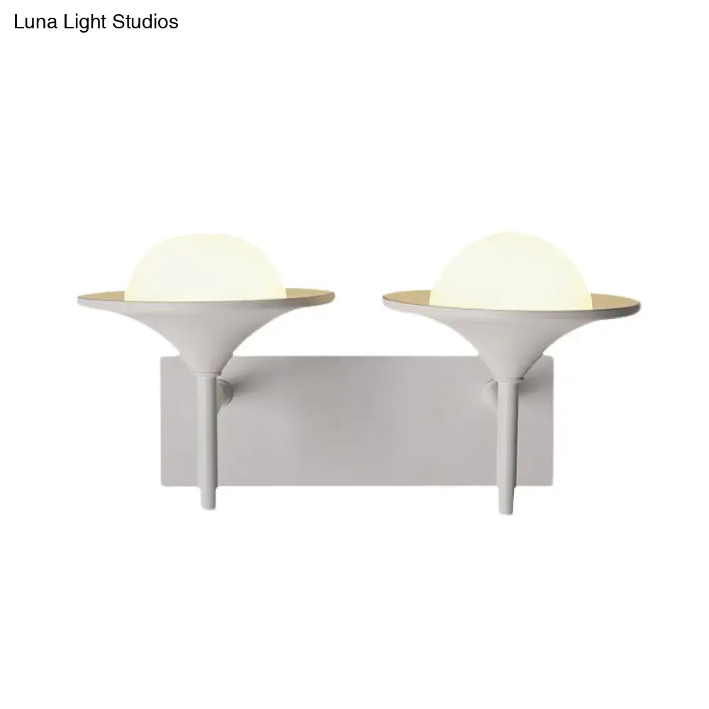Modern white metallic flared wall sconce with dual sleek matte white heads and warm frosted dome LED light for bedroom use