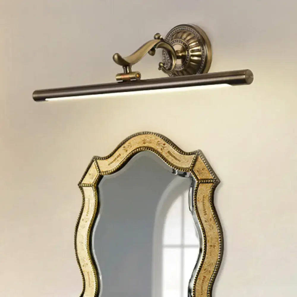 Antique brass-finished linear metallic vanity wall light with cylindrical bar and ornate decorative backplate