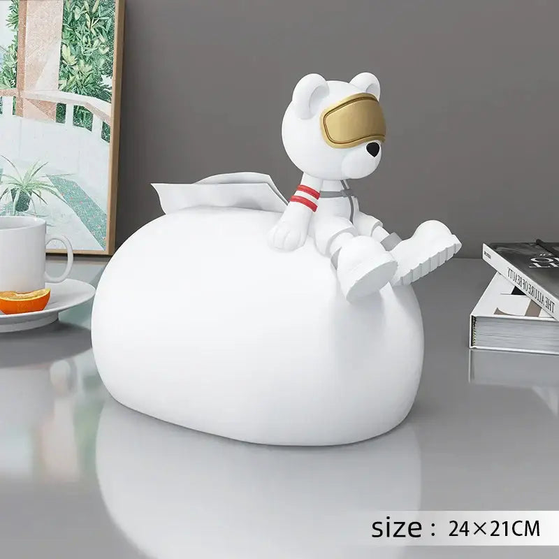 White astronaut-themed tissue box holder with glossy finish and gold visor paired with nordic bear statues tissue decor