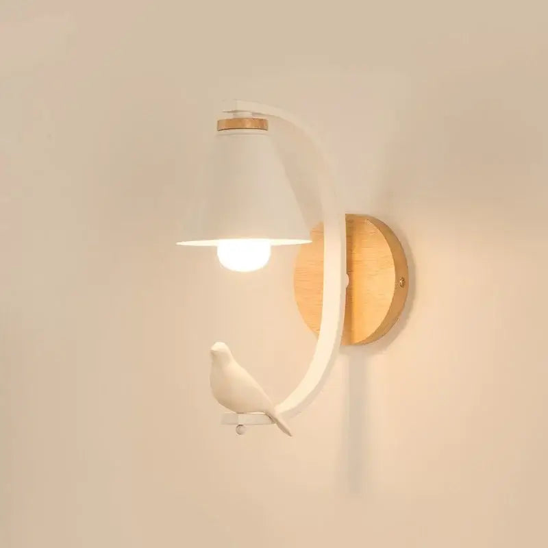 White ceramic birdie wall lamp with curved metal arm and wooden backplate for nordic bedroom lighting