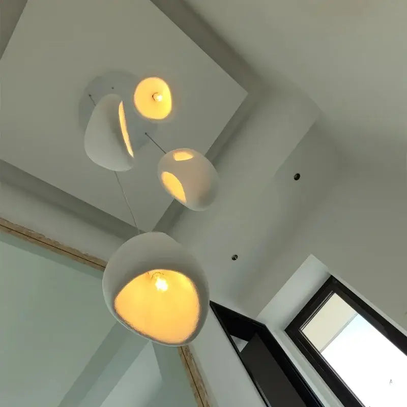 Modern white ceramic pendant lights with warm glowing interiors for dining room decorbites designer led pendant lighting