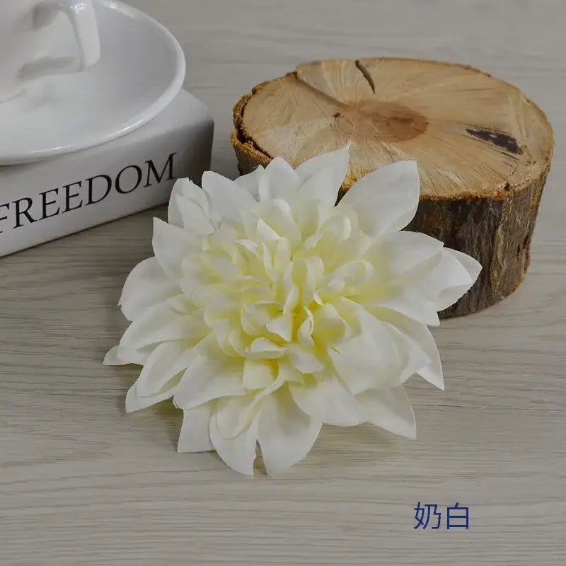 A delicate ivory woolen chrysanthemum wreath bouquet with layered soft petals for wedding or bedroom decoration