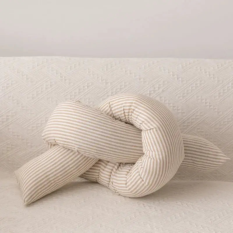 A soft cream-colored decorbites cloud star pillow with beige and white vertical stripes in a star moon shape