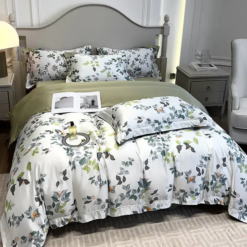 White duvet cover with delicate green and gray botanical print and subtle ruffled edges in decorbites ice silk plant bedding set