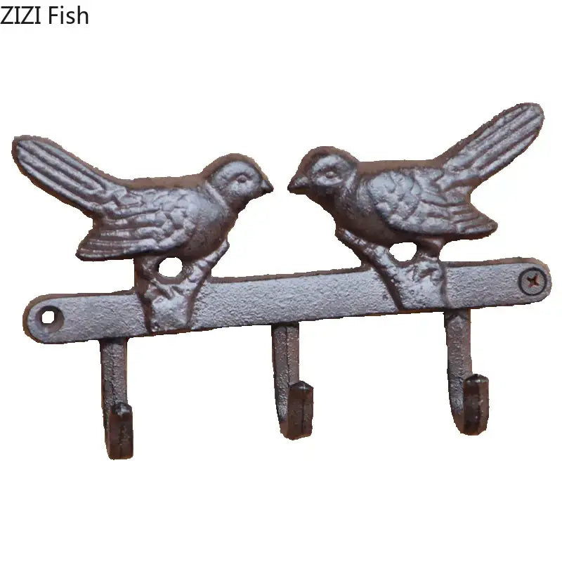 Vintage black iron bird hook wall shelf with two detailed birds and three hooks in rustic gray patina for entryway storage