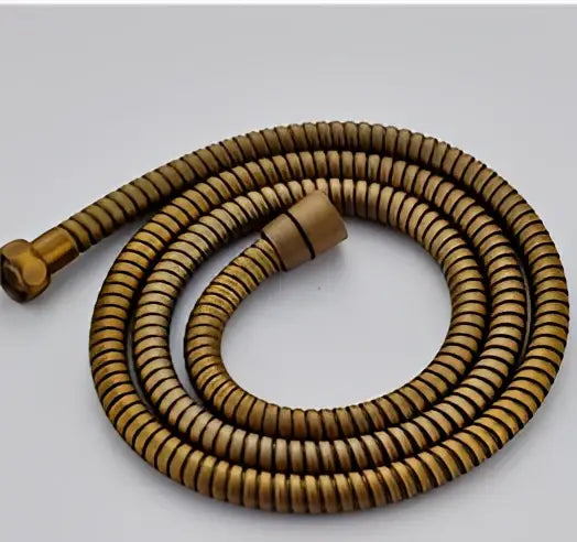 Vintage brass handheld shower hose in bronze with flexible coil, ribbed texture, and brass connectors for shower head