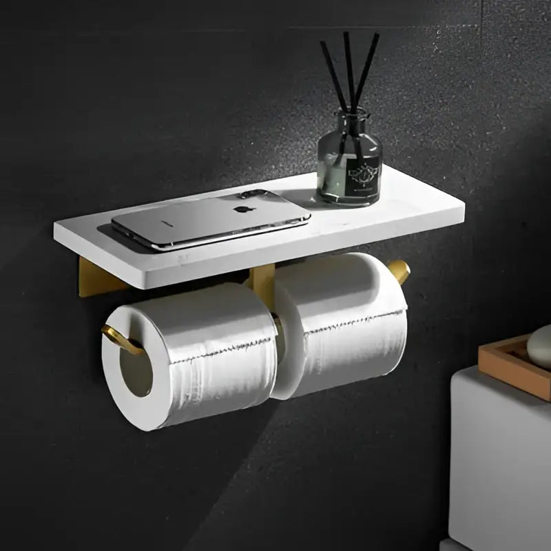 White marble-effect wall-mounted paper holder with gold marble fixtures holding two white toilet paper rolls for bathroom decorbites gold marble