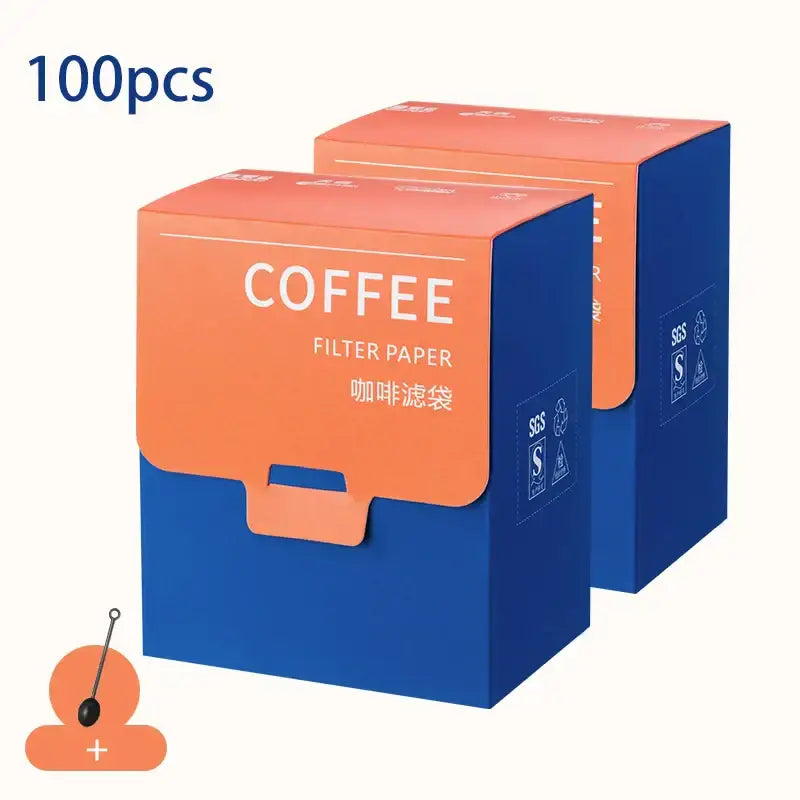 Two vibrant orange and blue decorbites coffee filter bags made of cardboard for white disposable kitchen pour over use