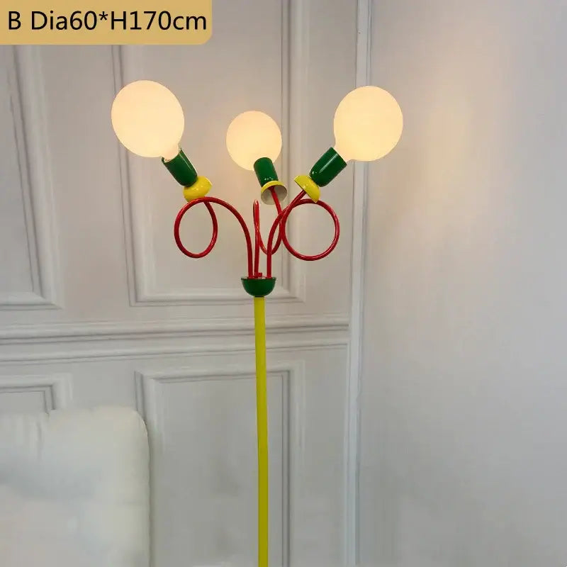 Vibrant three-armed floor lamp with yellow pole, red curved arms, green accents, and glowing bulbs for decorbites colorful led floor