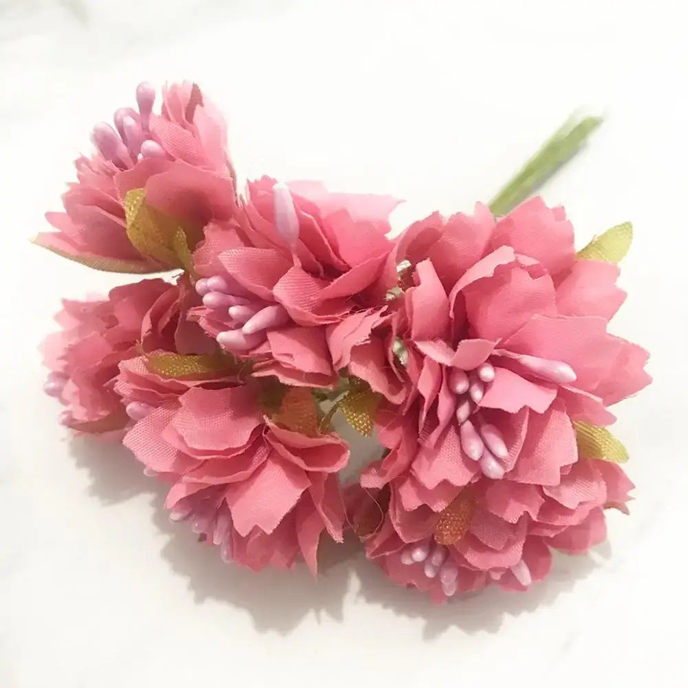 A cluster of 200pcs mixed rose red fabric flowers with layered petals and white stamens for bedroom diy decor