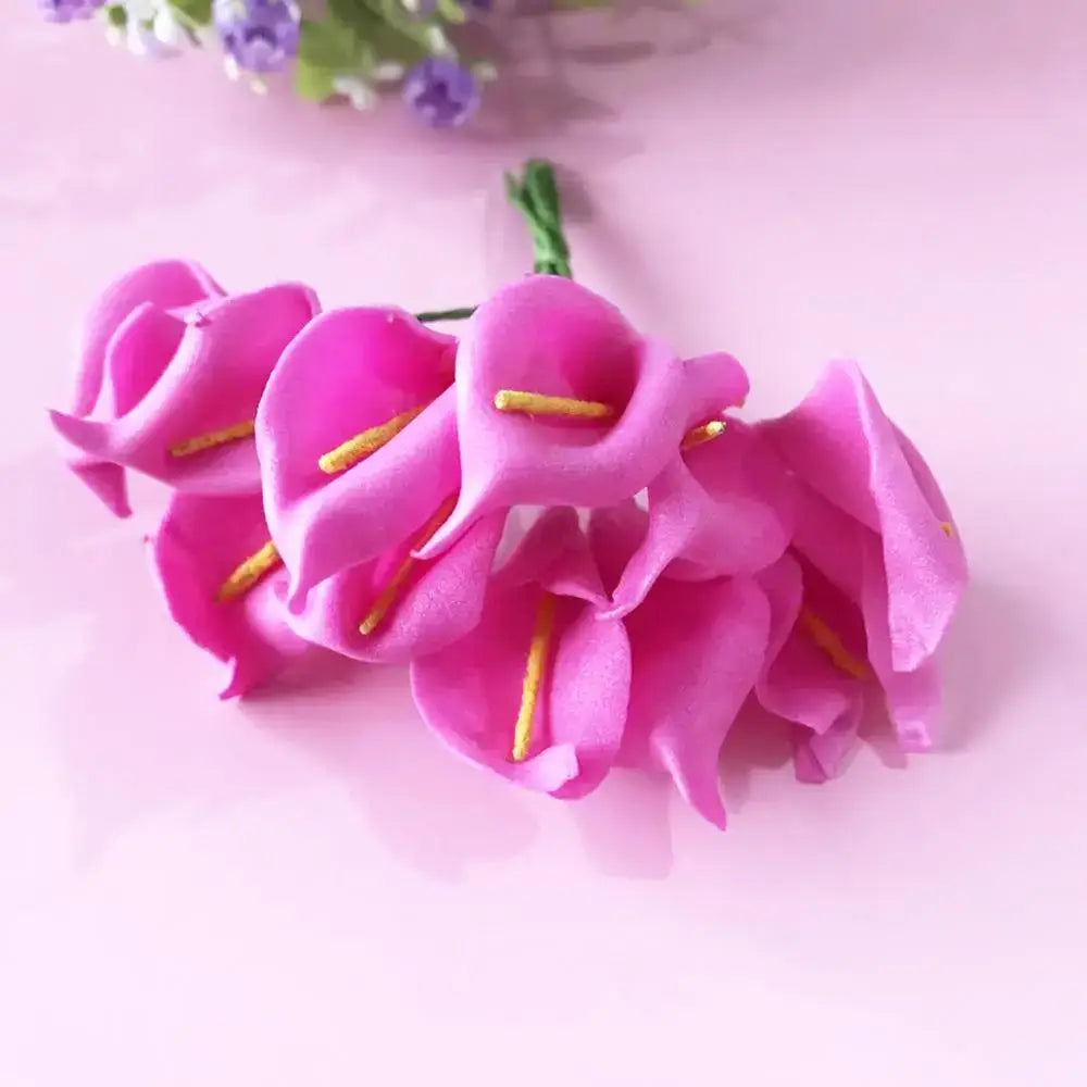 A cluster of vibrant pink artificial calla lilies with yellow stamens in a 200pcs mixed rose red flower stamen bundle for diy decor