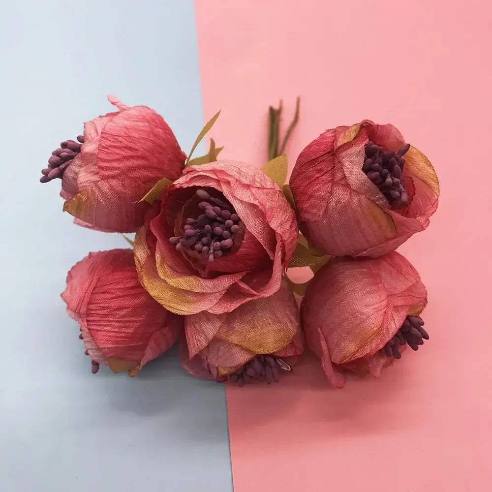 A cluster of five artificial mixed rose red peonies with textured pink peach petals and green stems for bedroom decor