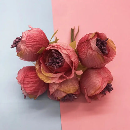 A cluster of five artificial mixed rose red peonies with textured pink peach petals and green stems for bedroom decor