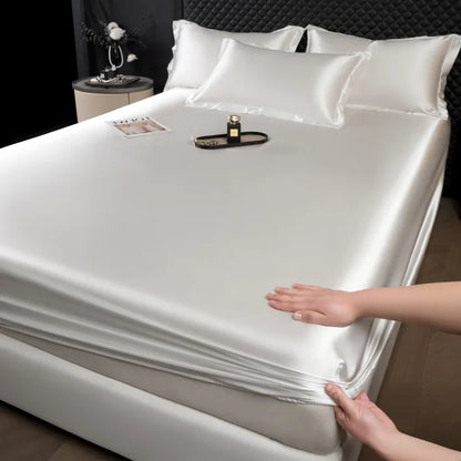 A sleek white 3 pcs mulberry silk sheet set with satin finish fitted sheet featuring elasticized edges for luxury comfort