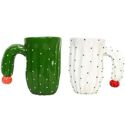 A green and white decorbites 3d cactus style ceramic mug with a dotted handle shaped like a prickly stem topped with a red berry