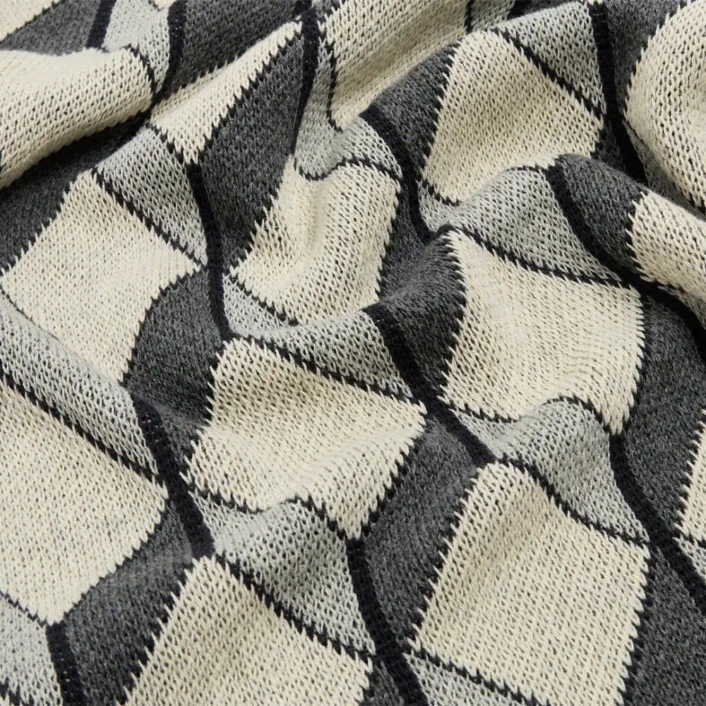 A cube cotton knitted scarf with a geometric diamond pattern in black gray and off-white matching decorbites 3d cube plaid blanket