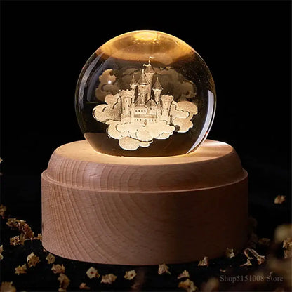 A warm-lit decorbites crystal ball night light with an engraved castle on a wooden music box base for bedroom decor