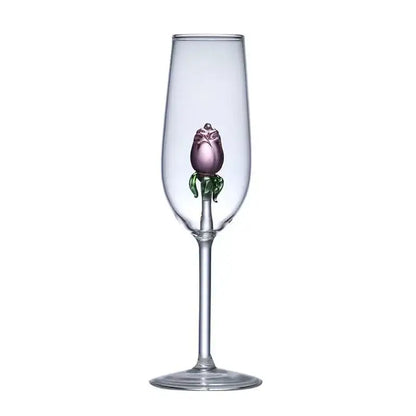 A clear glass champagne flute with a hand-blown purple and green glass rose wine stem from decorbites 3d pink set