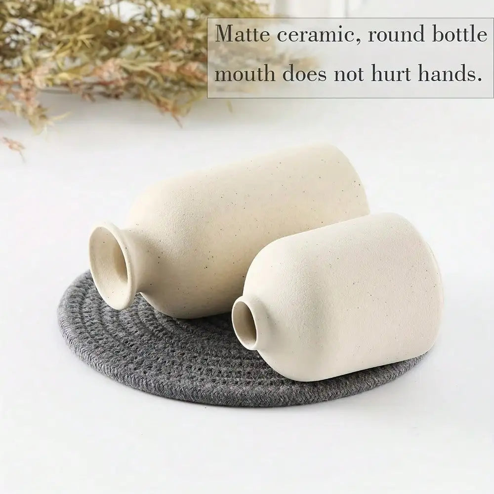 Two matte off-white ceramic vases with rounded curves from a 3pcs bohemian farmhouse home decoration set