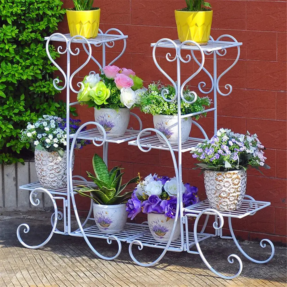 Decorbites™ white metal plant stand with ornate scrollwork and three tiers holding colorful ceramic pots for indoor outdoor use
