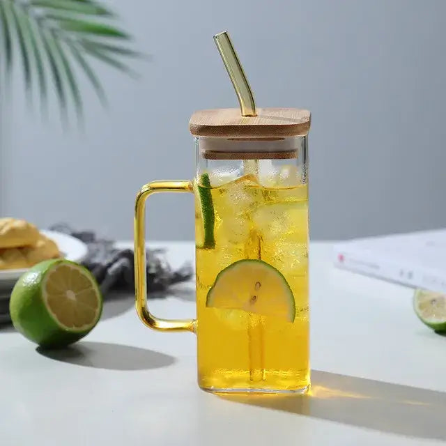 400ml square glass mug with gold handle and bamboo lid filled with iced yellow drink and lime slices for dining use