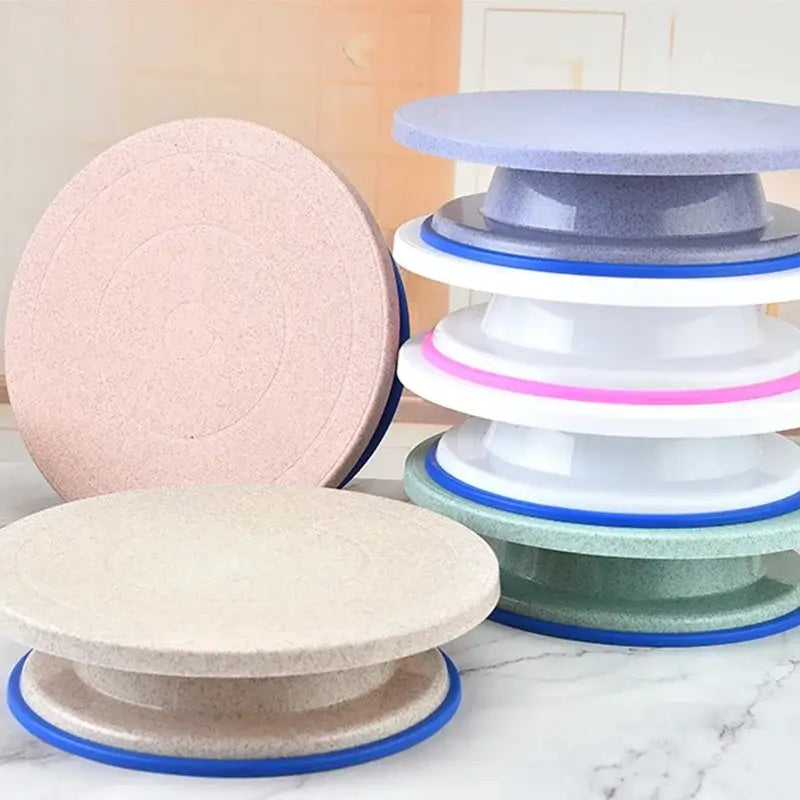 Stacked multi-tiered pastel cake decorating turntable set with blue rubberized bases and speckled texture by decorbites