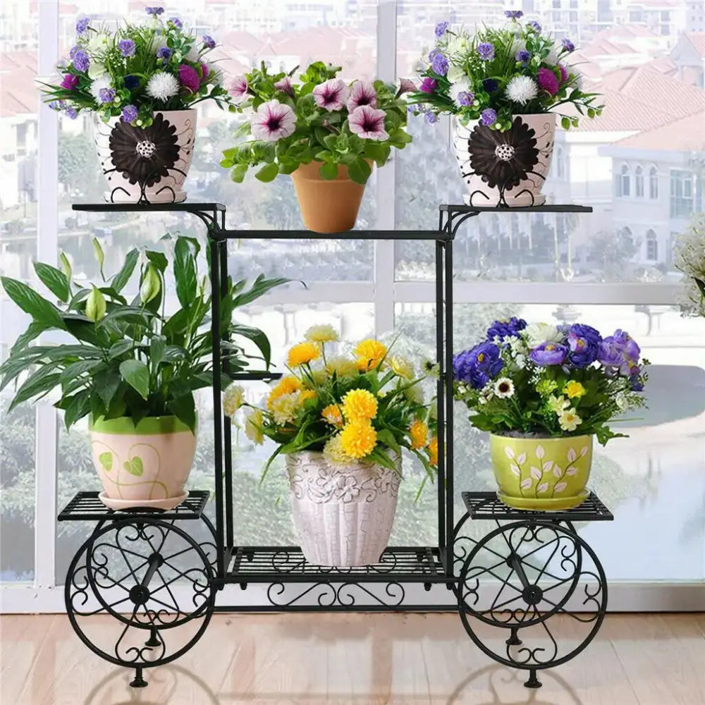 Decorbites 6-tier black wrought iron metal plant stand with ornate wheels and multiple shelves for indoor and outdoor use