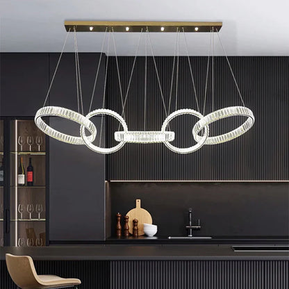 Modern gold-toned decorbites crystal chandelier pendant light featuring four interlocking crystal rings for ceiling lighting