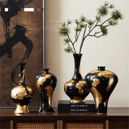Set of four black ceramic vases with elegant gold foil pattern and glossy finish for living room decor