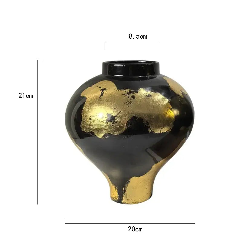 A glossy black ceramic vase with abstract gold foil pattern accents and a flared base for living room decor