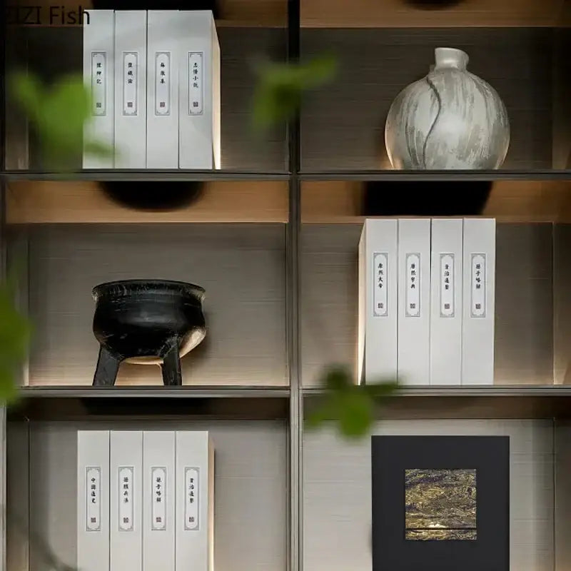A sleek modern bookshelf with warm wood accents next to a black and gold gilded fabric hanging painting decorbites