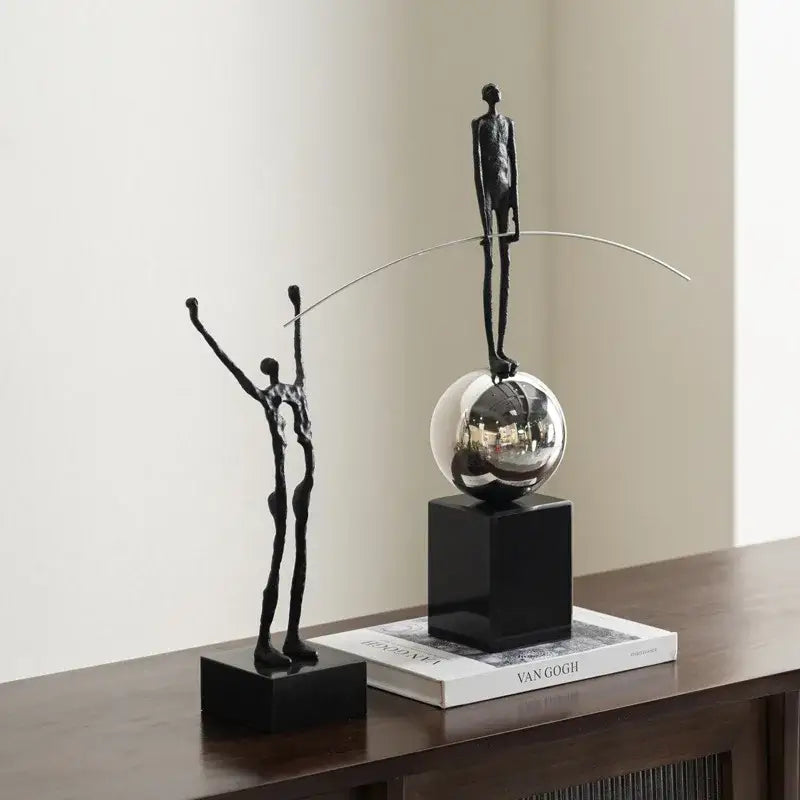 Abstract black and silver human figure sculpture with slender form on reflective sphere for living room decorbites human figure