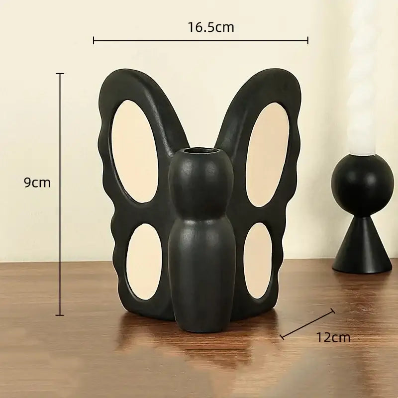 Abstract black butterfly ceramic vase featuring three oval cutouts and a central opening for living room decorbites black butterfly decor