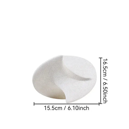 A minimalist white ceramic gyroscope ornament with smooth curves and subtle texture for living room decor