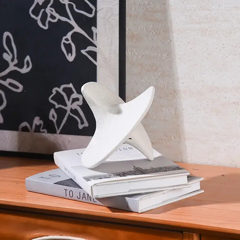 White ceramic geometric ceramic gyroscope bookend with modern abstract twisted design for living room decor