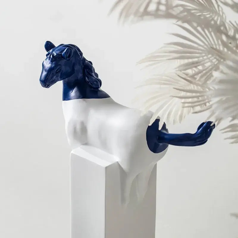 A sleek two-toned ceramic decorbites horse statue with glossy navy blue head and tail and smooth white body for living room decor