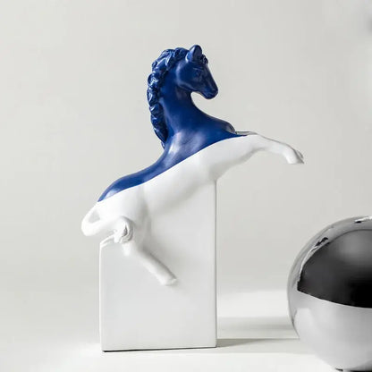 A striking blue and white ceramic decorbites horse statue in a dynamic rearing pose with a glossy finish on base