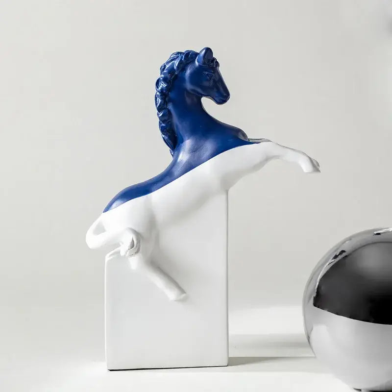 A striking blue and white ceramic decorbites horse statue in a dynamic rearing pose with a glossy finish on base