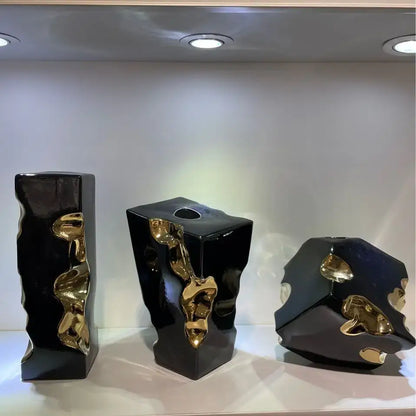 Three glossy black ceramic vases with abstract golden notch ceramic accents for decorbites golden notch living room decor