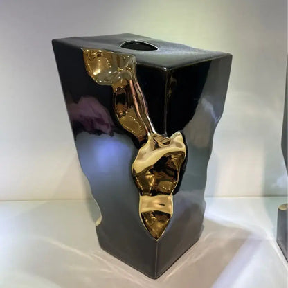 Black ceramic tissue box with glossy finish and abstract gold metallic sculpture decorbites golden notch decor accessory