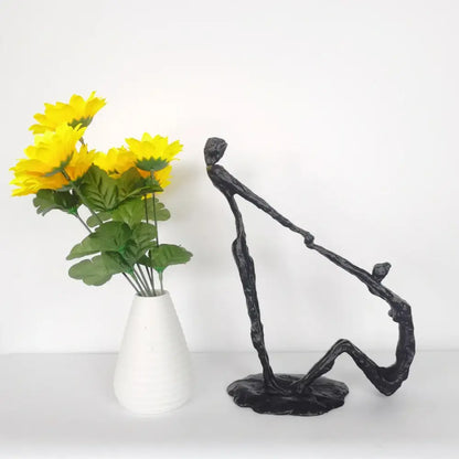 Abstract black hand dance sculpture of two intertwined figures on a base for living room adolescence decor