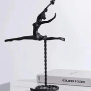 Abstract black metal ballerina dancer sculpture in mid-air split pose with twisted rope base for living room decor