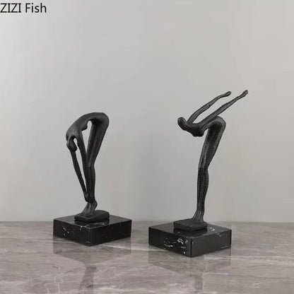 Two sleek black metal abstract gymnast statue desk ornaments on polished dark marble bases for decorbites decorbites gymnast statue